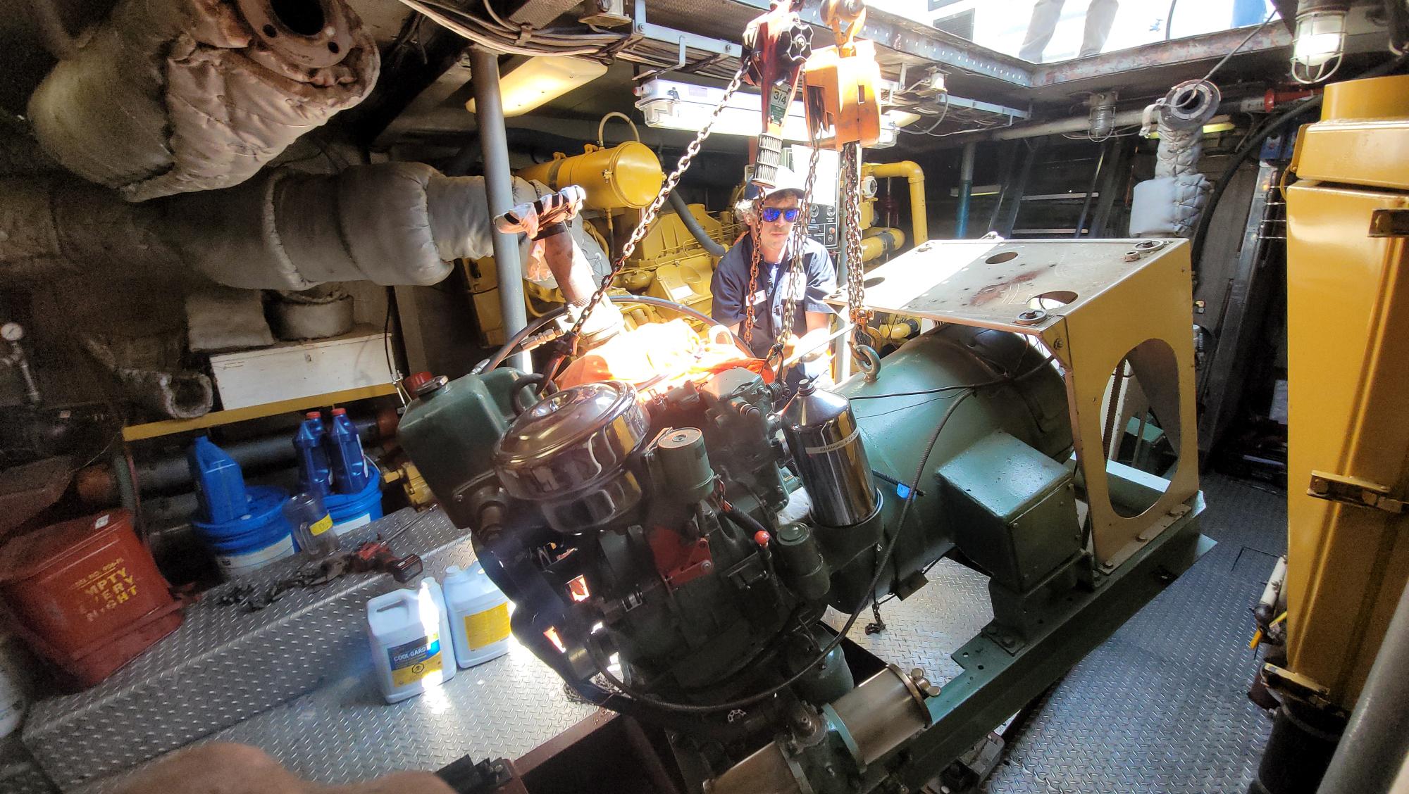 Old generator gets crane lifted to make room for new generator on Seattle Maritime Academy's training vessel, the Maritime Instructor