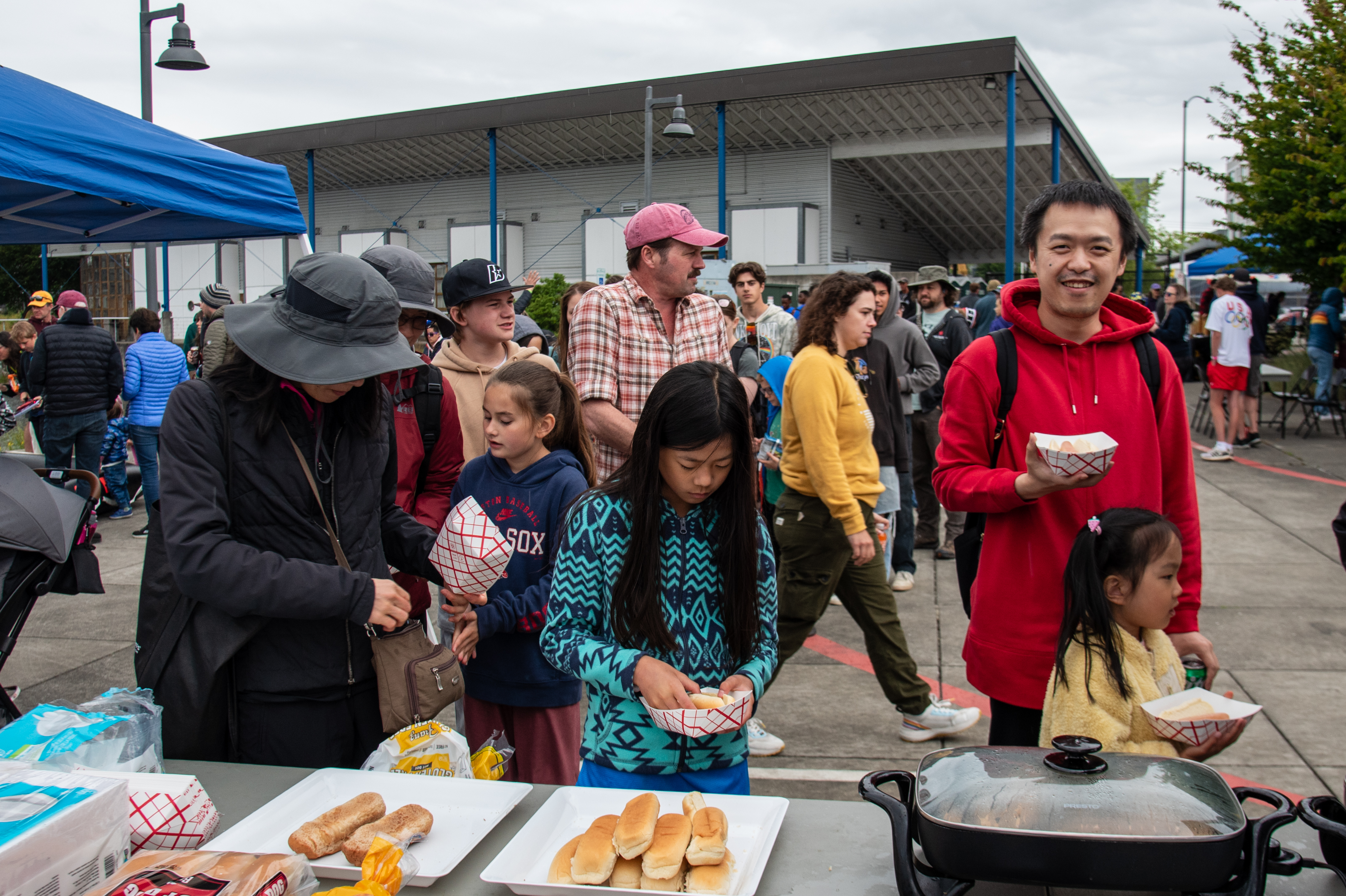 Community Day attendees getting hot dogs