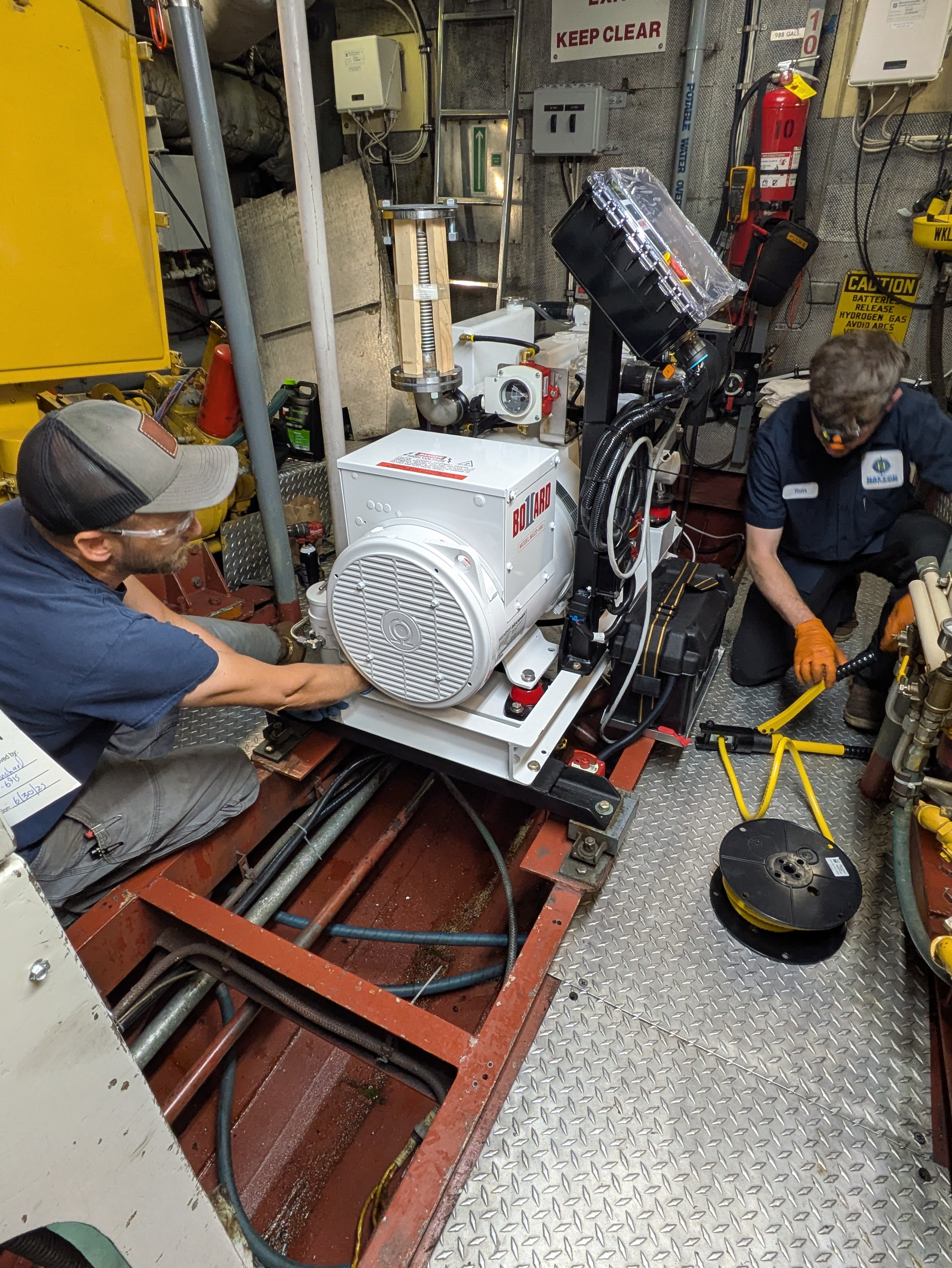Staff installing new generator